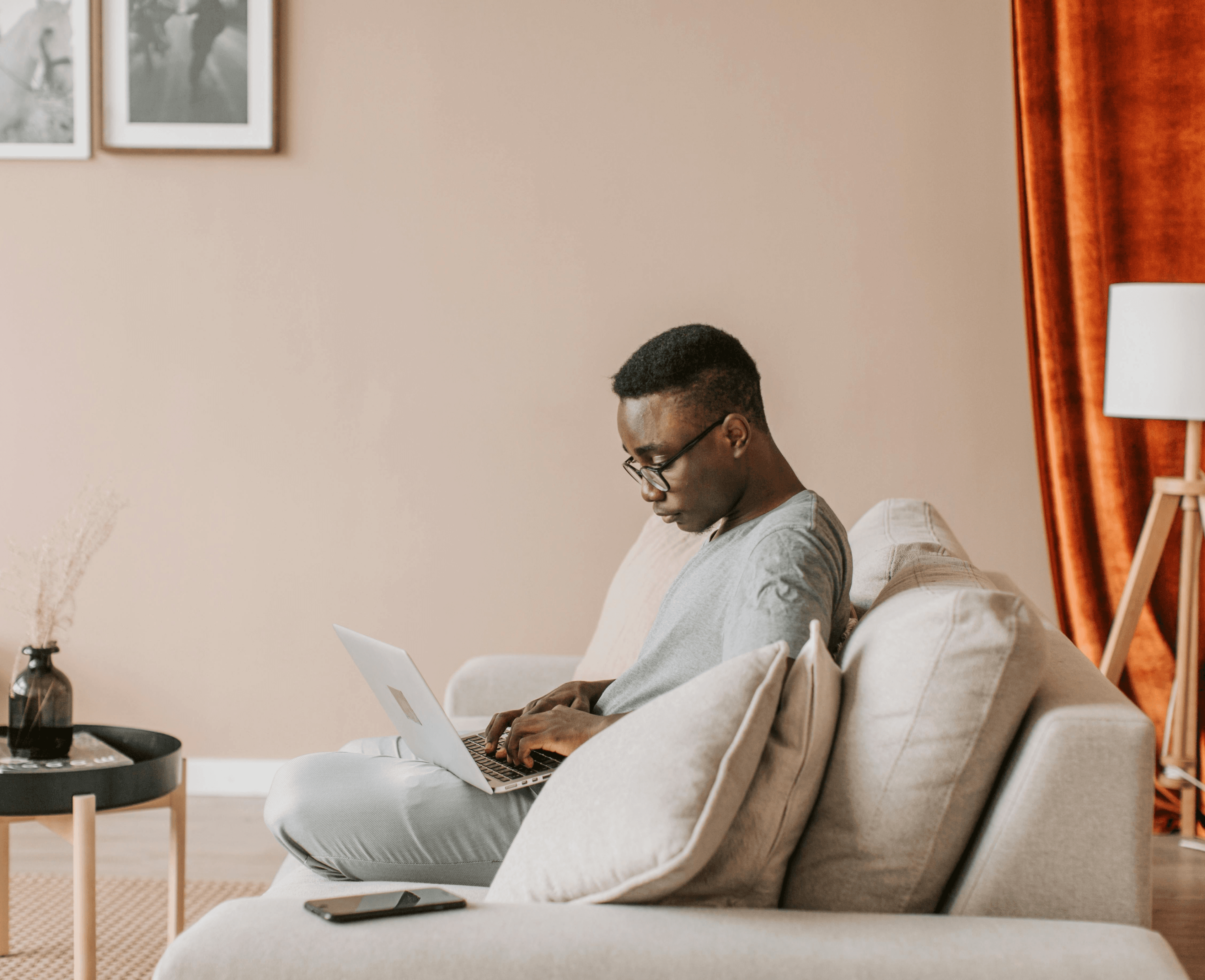 Guy on laptop on couch image.